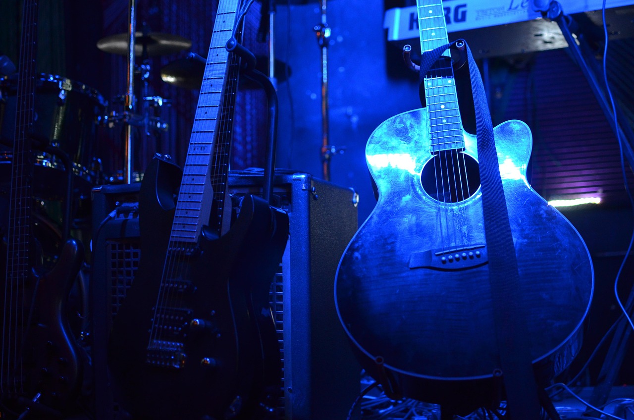 Guitars on a blues stage lit in blue light